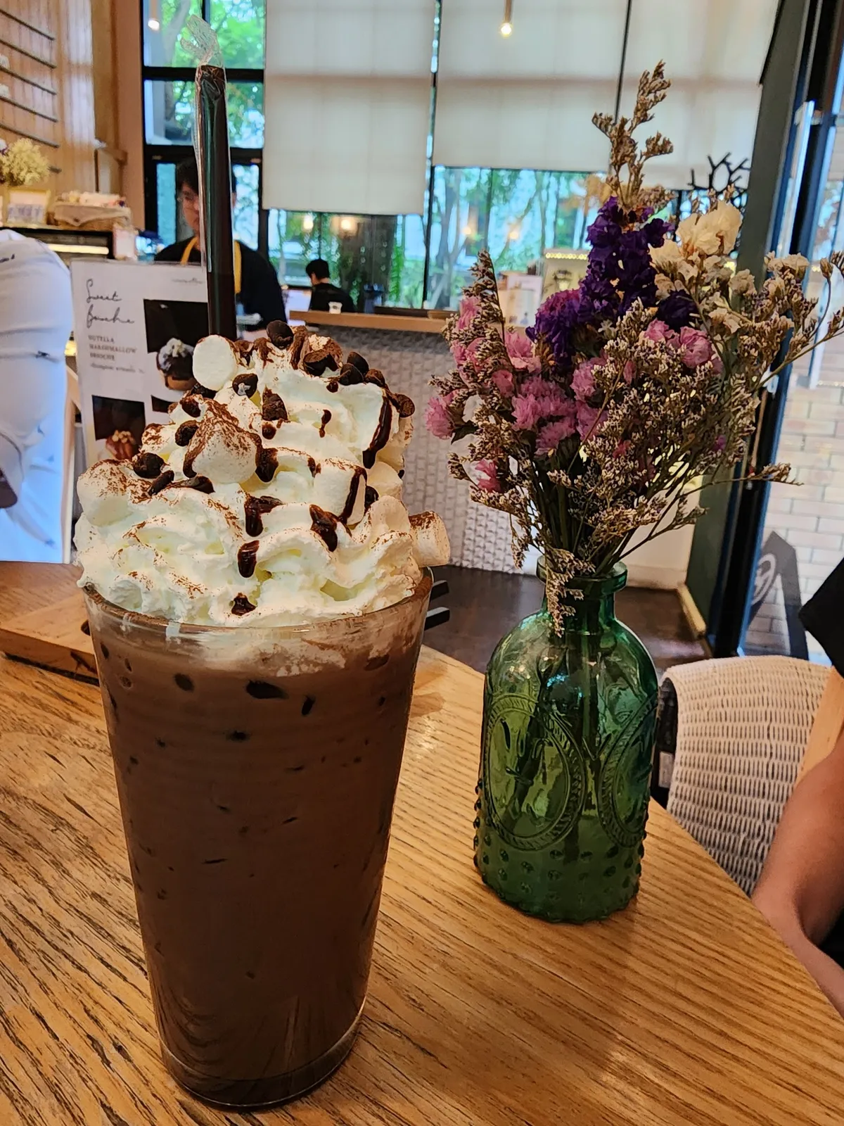 A signature iced chocolate with whipped cream and marshmallows
