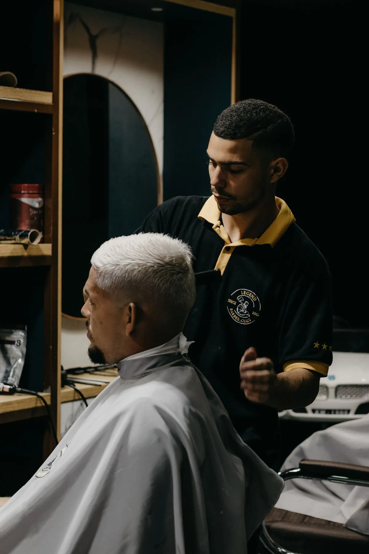 A barber and client at the mirror