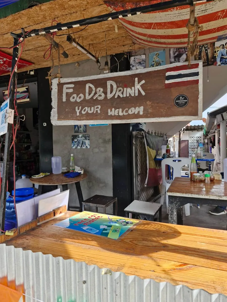 The shophouse counter under its hand-painted “Food & Drink — your welcom” sign