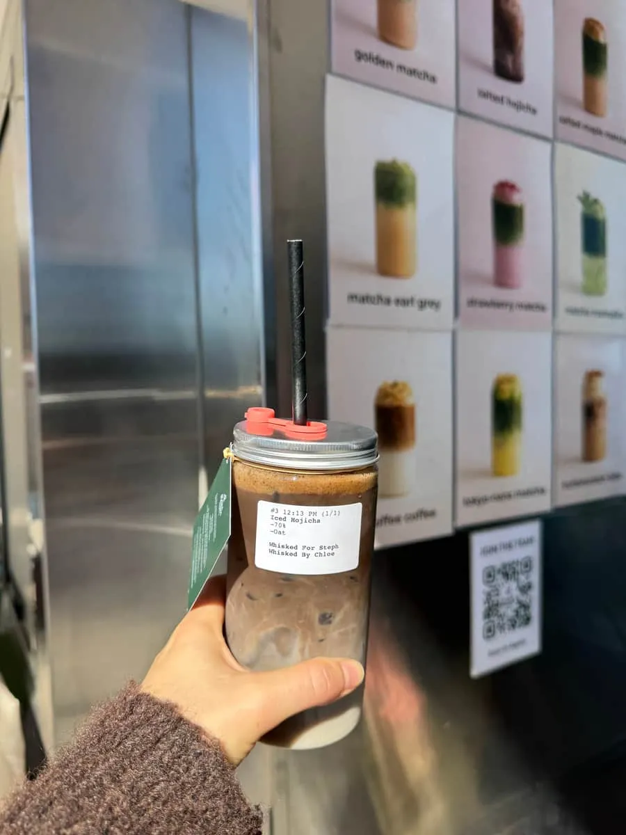 An iced hojicha in a mason jar — deep roasted-tea brown over milk
