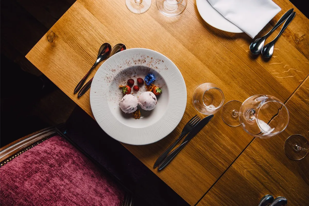Plated dessert with berries and a dusting of spice