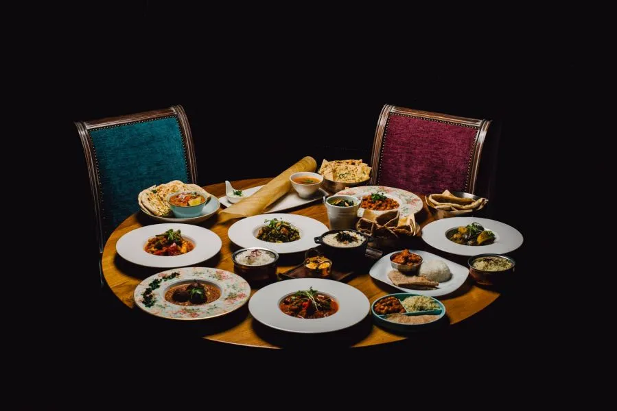 A sharing feast of Prashad dishes laid across the table