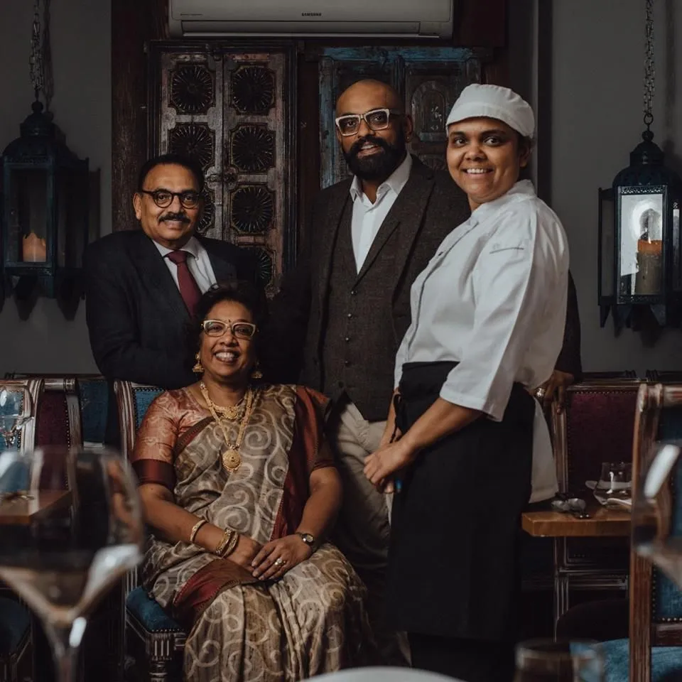 The Prashad family and head chef in the restaurant dining room