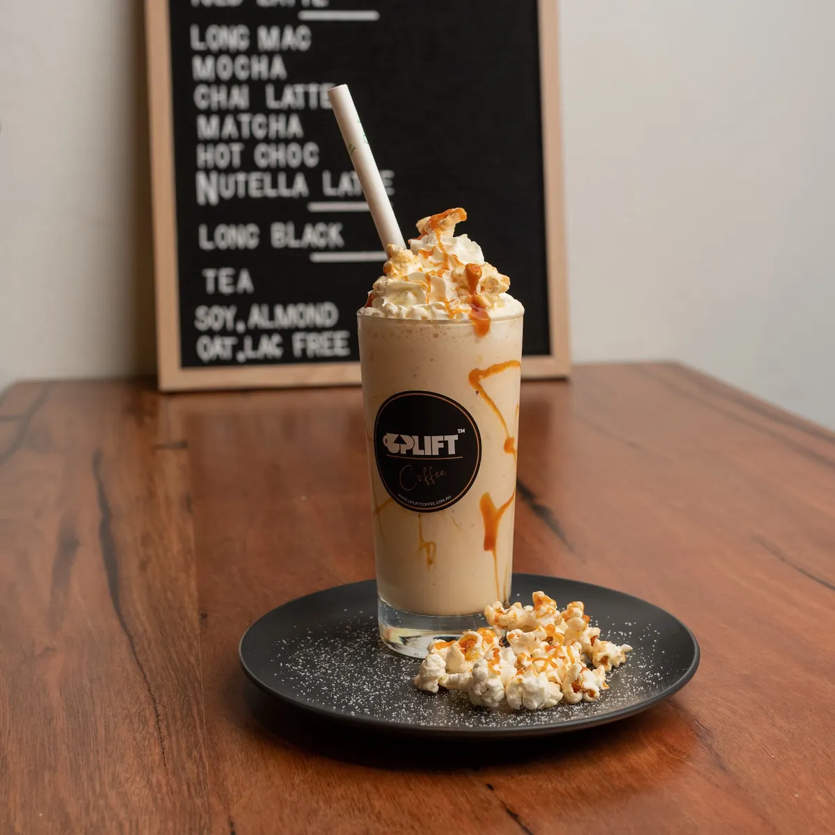 Caramel popcorn milkshake in an Uplift glass