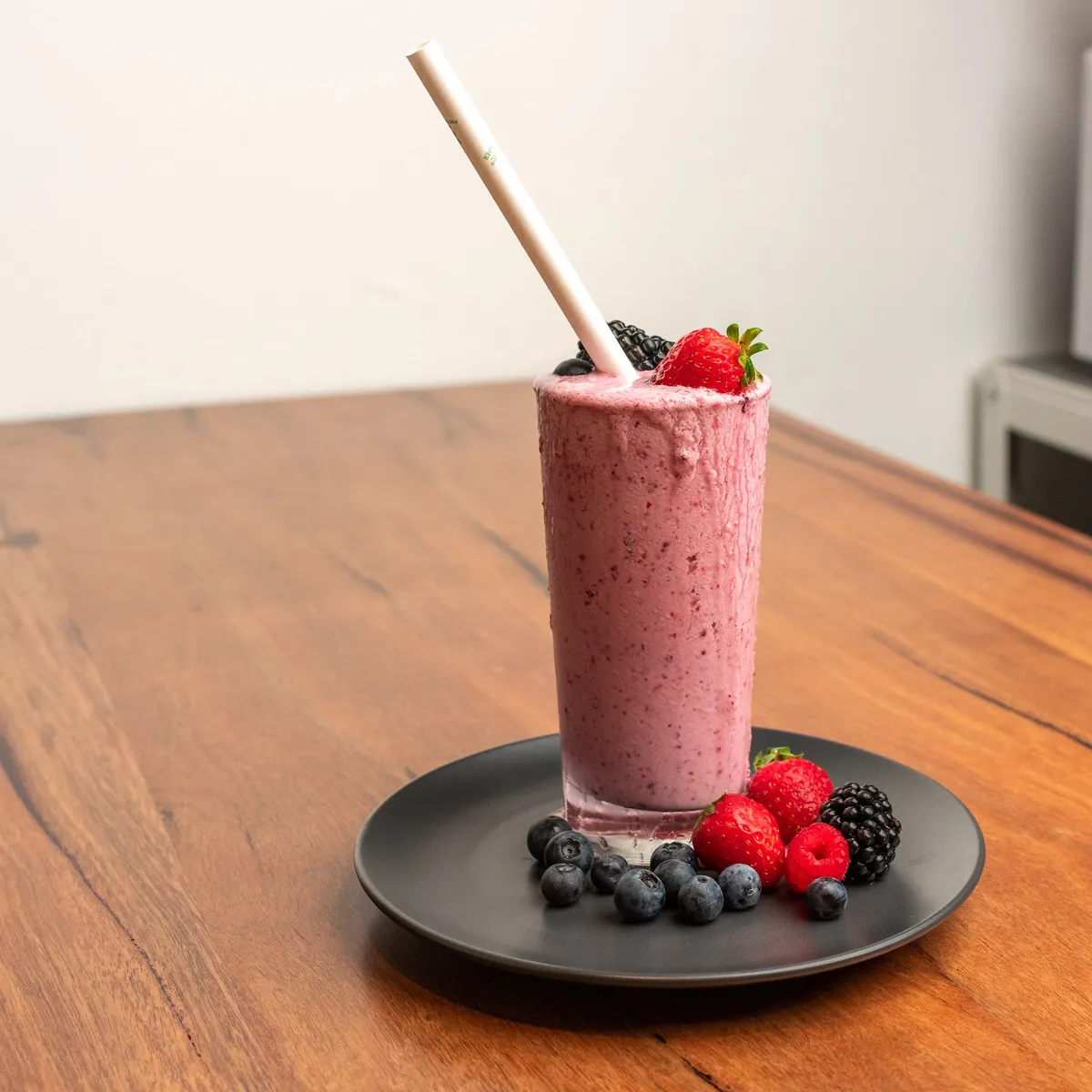 Berry smoothie topped with fresh berries